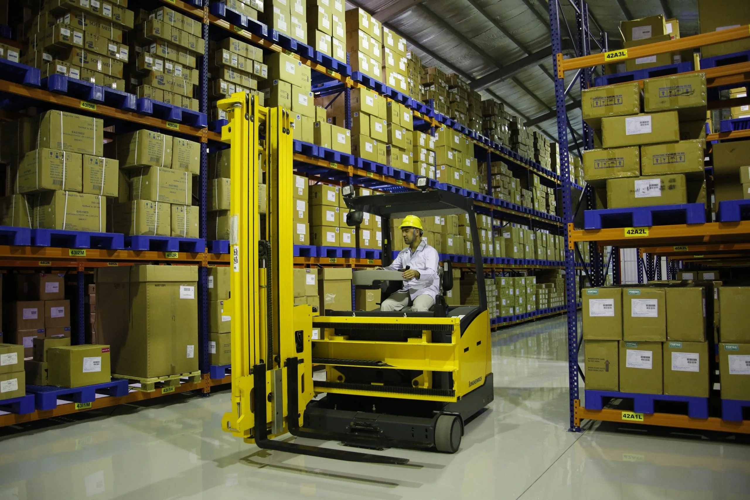 Forklift operator moving pallets in a Kawkab Scientific Bureau GDP warehouse